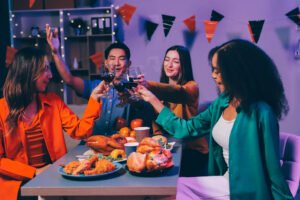 Joyful office Halloween party with coworkers in costumes, celebr