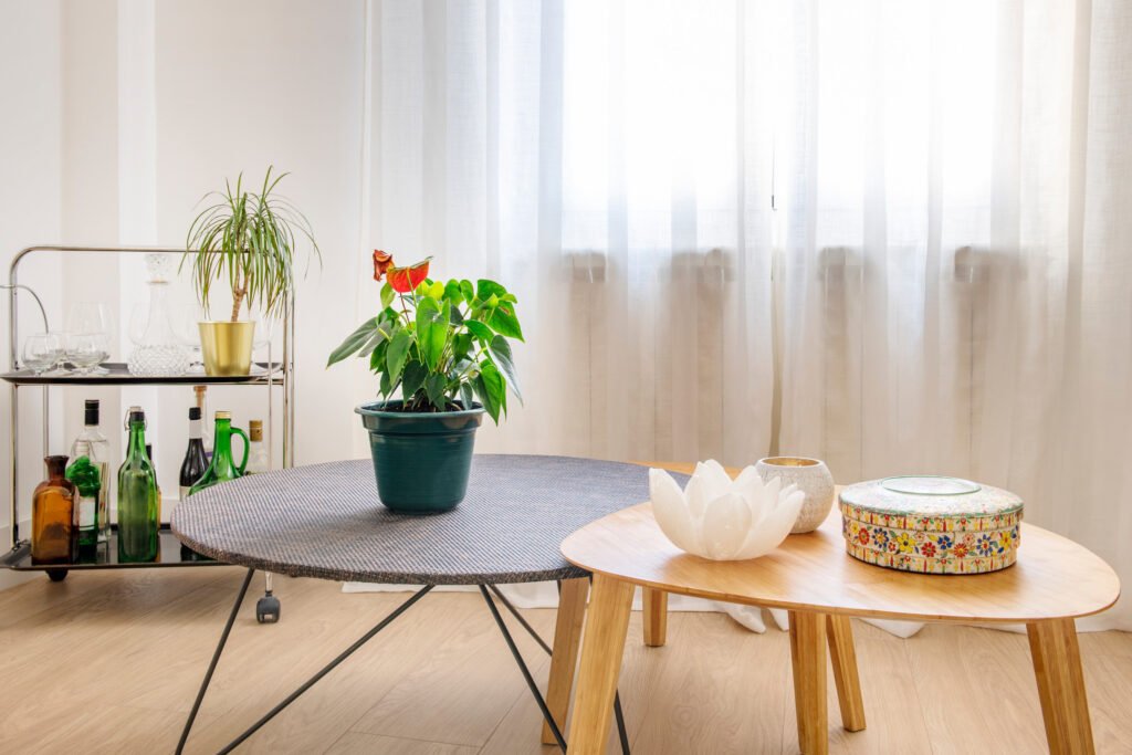 Decorative coffee tables and drinks cart in a living room with w